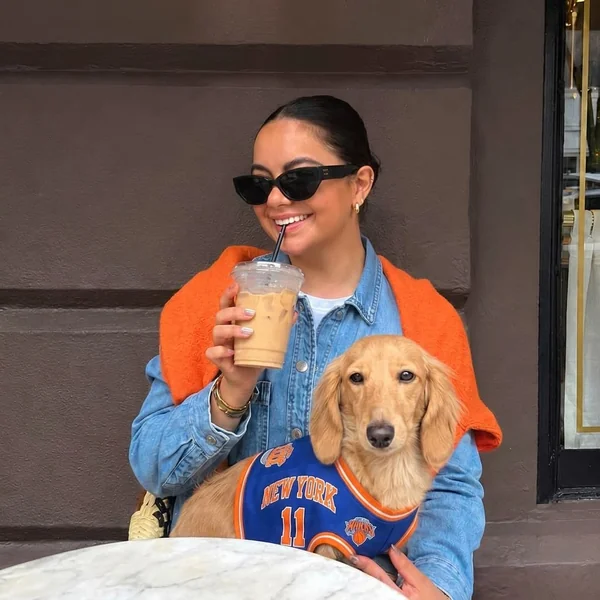 Denim Jacket and Shoulder-Draped Orange Sweater