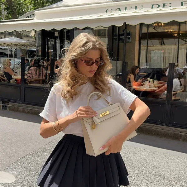White T-Shirt and Pleated Black Mini Skirt