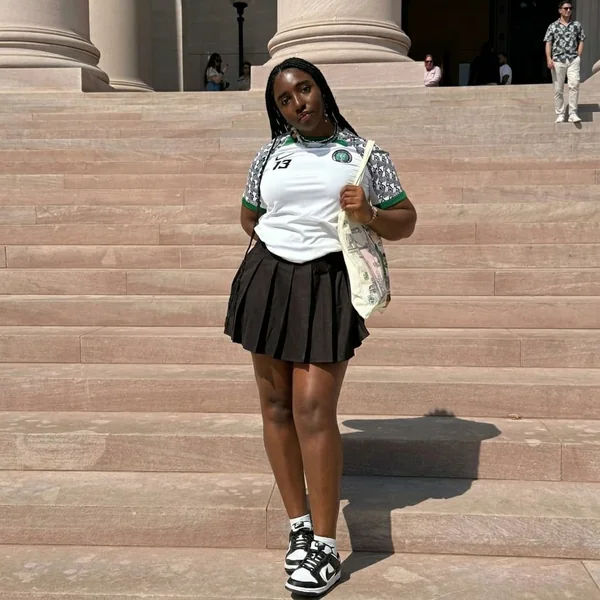 Sporty Chic with a Black Pleated Skirt