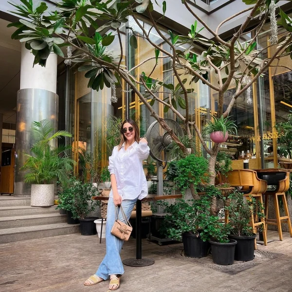 Oversized white shirt with light wash flare jeans
